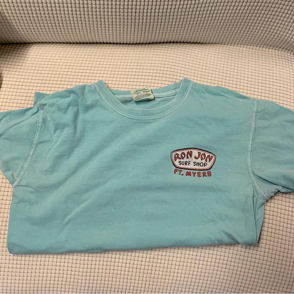 small light blue ron jon t shirt